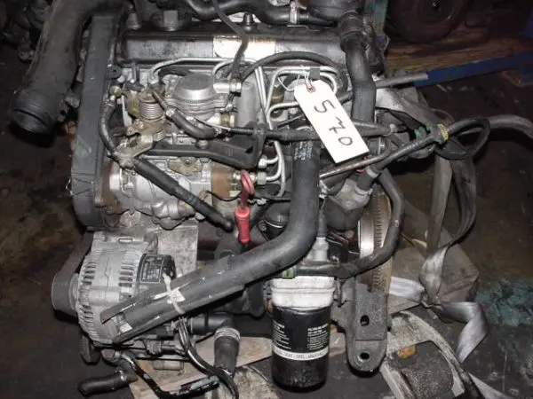 Used car engine with parts attached.