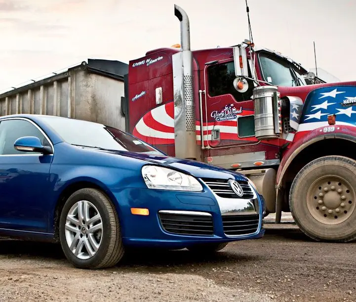 Blue car and red truck parked together.