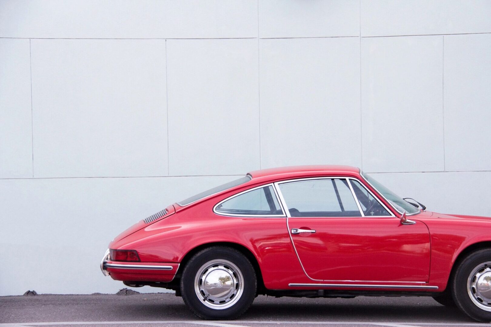 A red car parked in front of a building.