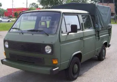 A green van is parked in the parking lot.
