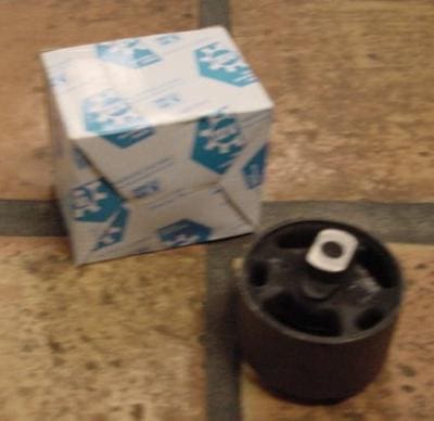 Car part in box on tile floor.