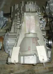 A silver car transmission with tags.