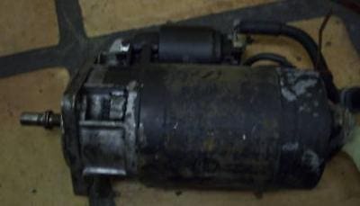 Close-up of a dirty car starter motor.