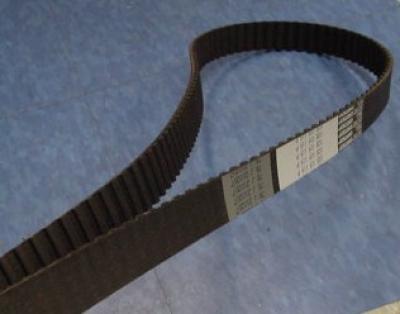 Brown ribbed timing belt with text.