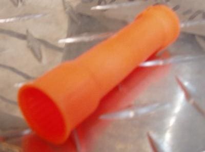 Orange rubber tube on a metal surface.