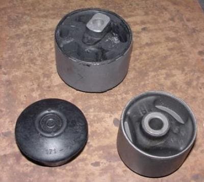 Three automotive engine mounts.