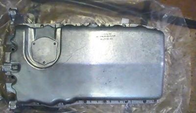 Metal engine oil pan with bolts.