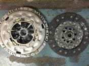 Two car clutch plates on a table.