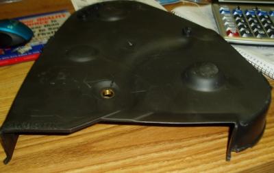 Black plastic car engine cover part.