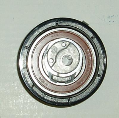 Silver car engine timing pulley.