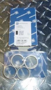 Four silver piston rings in a package.